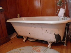 Clawfoot tub with peeling paint.