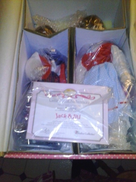 Two dolls in box.