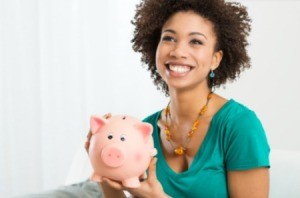 A woman holding a piggy bank.