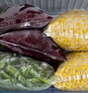 Frozen vegetables in freezer safe bags.