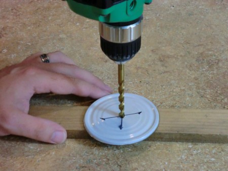 drilling holes in a can lid.