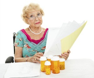 A woman looking at Medicare paperwork.