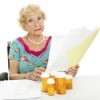 A woman looking at Medicare paperwork.
