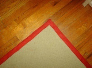 A carpet remnant turned into an area rug or doormat.