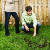 Couple Looking at Bare Spots in Lawn
