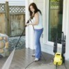 Woman Spring Cleaning Outside With Pressure Washer