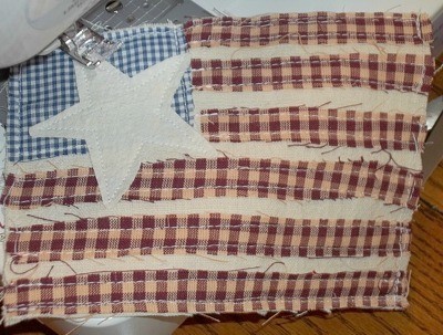 Primitive Applique Flag Pillows - Sewing on star.