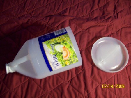 A vinegar bottle with the bottom cut out.