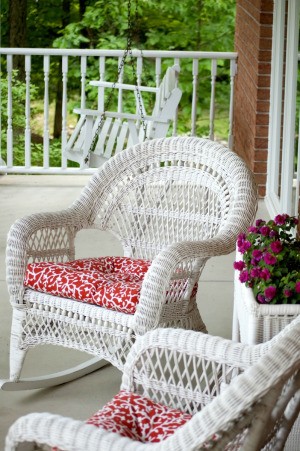 Outdoor wicker style chairs with fabric covered seat cushions.