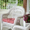 Outdoor wicker style chairs with fabric covered seat cushions.