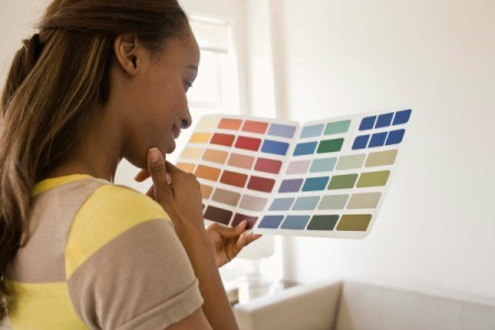 a woman looking at paint swatches.