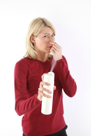 Woman Deodorizing in Her Home