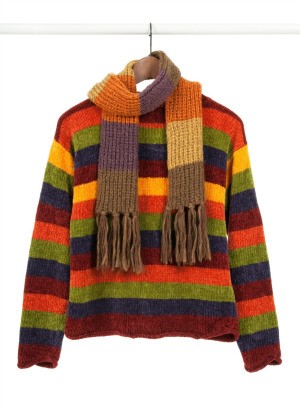 Colorful sweater hanging in a closet.