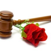 A courthouse gavel and a red rose.