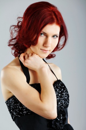 Woman with dyed auburn hair.