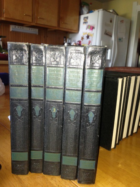 Five volumes of Compton's encyclopedia.