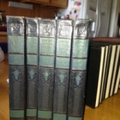 Five volumes of Compton's encyclopedia.
