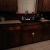 Dark brown cabinets in dated kitchen.