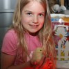 Girl holding baby chick.