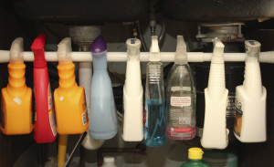 Closeup view of hanging spray bottles.