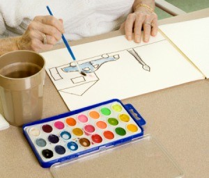 Adult painting a picture with watercolors.