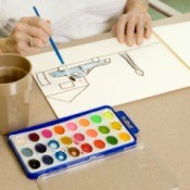Adult painting a picture with watercolors.