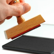 A hand holding a rubber stamp.