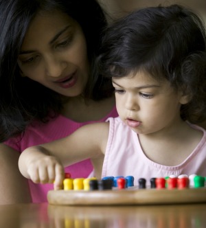 A mother playing a game with a toddler.