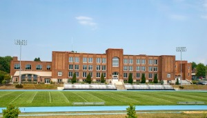 Photo of a large high school and its football field.