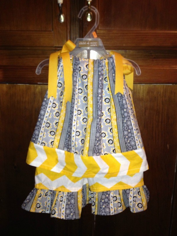 Sleeveless dress in blues and yellows.