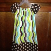 Cap sleeve dress with polka dot sleeves and bottom.