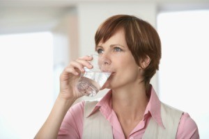 A woman drinking water.