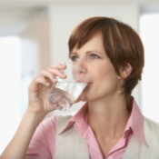A woman drinking water.
