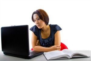 A girl taking an online course using her laptop.