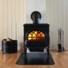 A wood stove with firelogs in it.