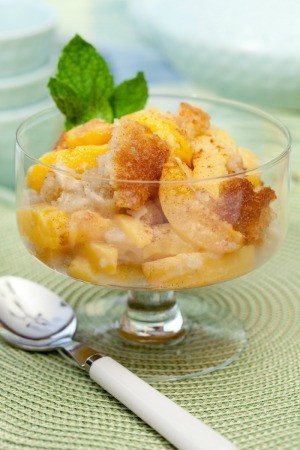 Peach Cobbler served in a glass dish.
