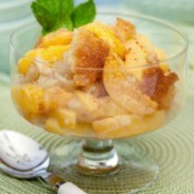 Peach Cobbler served in a glass dish.