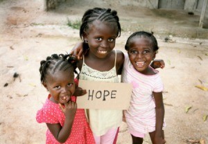 African children holding a sign that says hope.