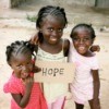 African children holding a sign that says hope.