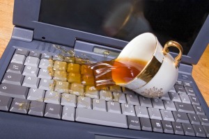 Tea spilling on a laptop computer keyboard.