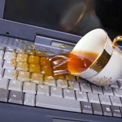 Tea spilling on a laptop computer keyboard.