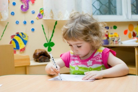 Preschool aged girl learning at home.