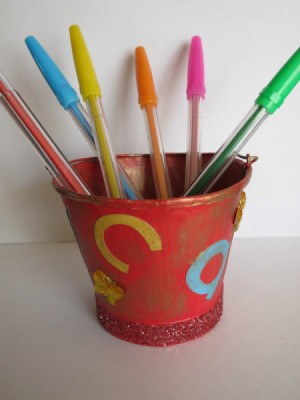 Bucket with colored pens.