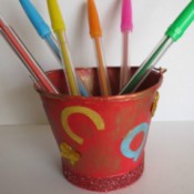 Bucket with colored pens.