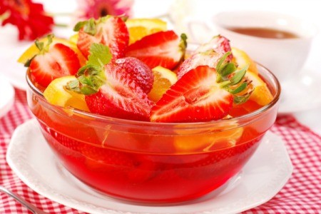 jello salad with red jello, strawberries and oranges.