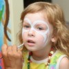 Girl having her face painted.