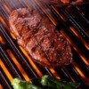 Tender rib eye steak on a grill.