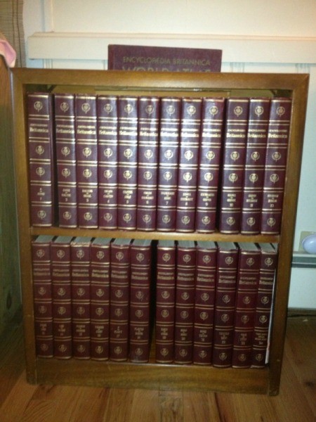 Encyclopedias on bookshelf.