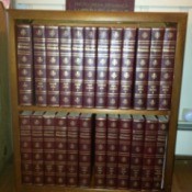 Encyclopedias on bookshelf.