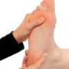 Using acupressure on a foot.